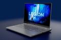 Image of a light grey laptop in front of a blue background with blue Legion branding on the display.