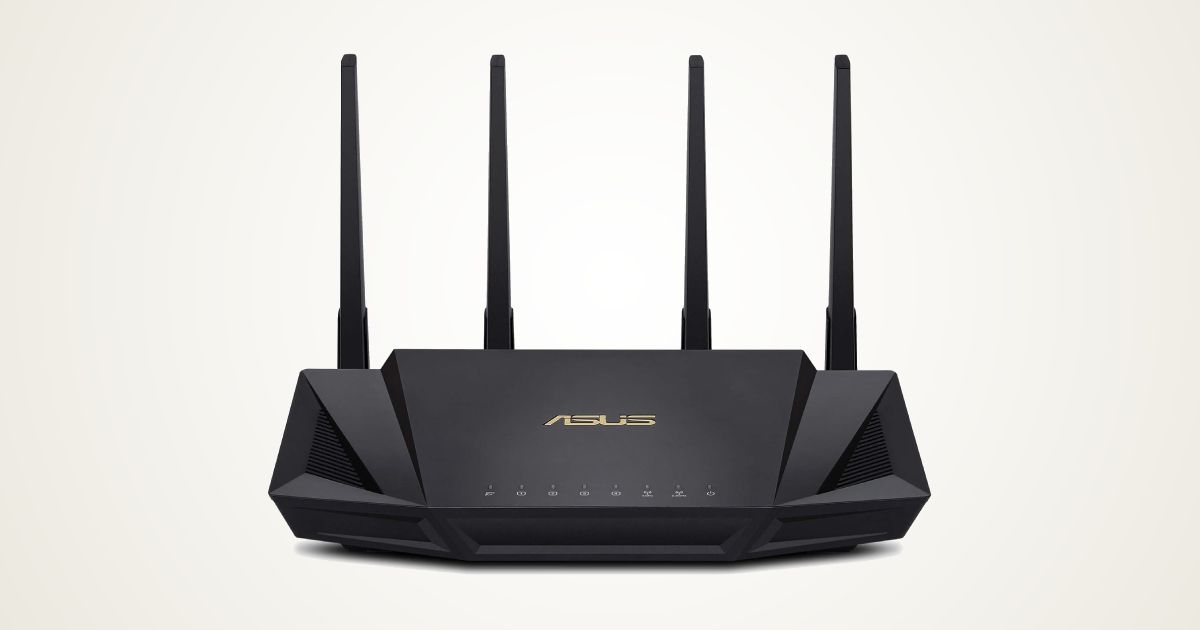 A black WiFi router with four antennae and ASUS branding in gold on top in front of a gradient white and gold background.