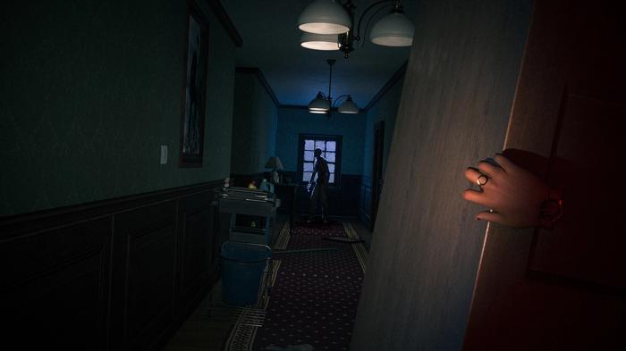 A shadowy figure stands at the end of a corridor as peer around a corner - upcoming VR games
