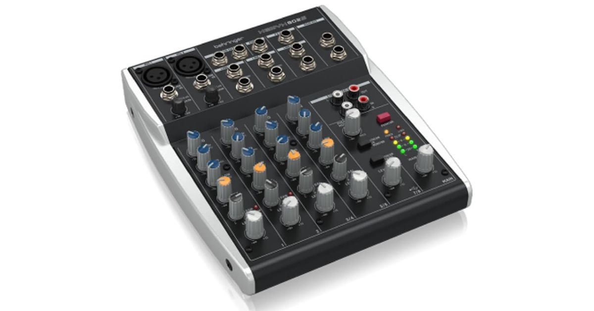 A black and white audio mixer featuring dark blue, orange, black, and white tips to its dials.