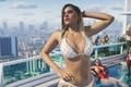 GTA 6 screengrab, woman in bikini stands near rooftop pool