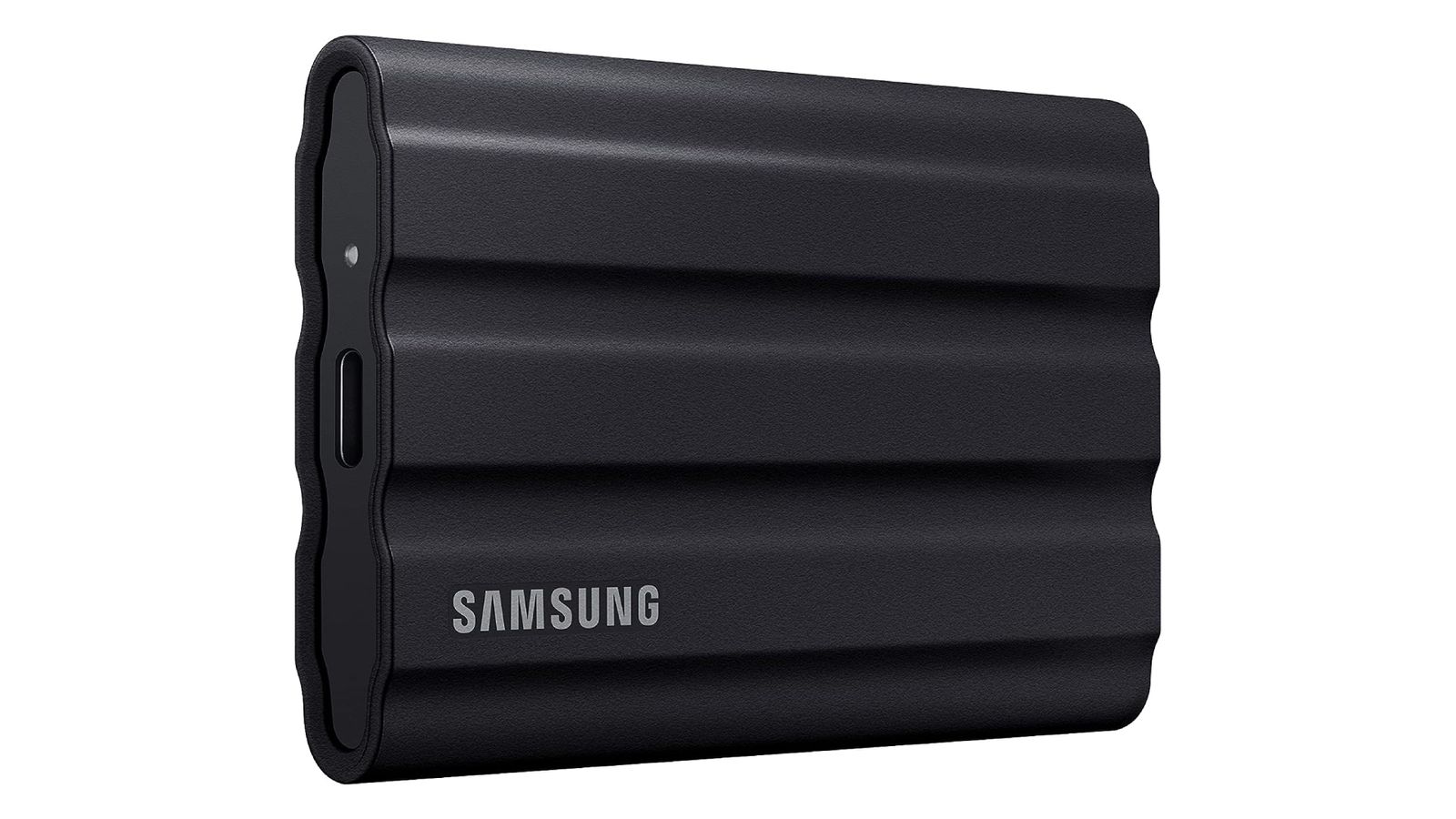 Samsung T7 Shield product image of a black, rectangular hard drive with grey Samsung branding in the corner.