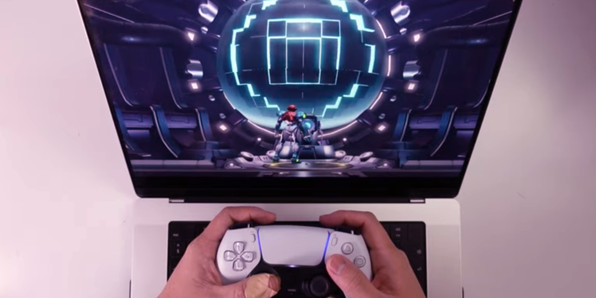 switch emulation runs on macos someone playing metroid dread on a laptop with a PS5 controller
