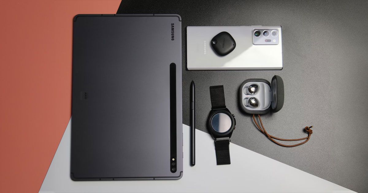 A collection of Samsung tech, including a black tablet, silver phone, and a black smartwatch.