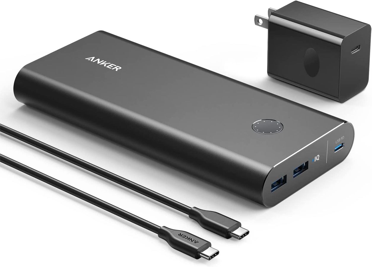Anker PowerCore+ product image of a dark grey power bank next to wires and a plug.