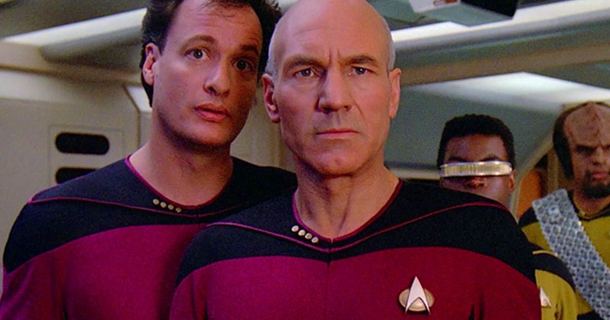 Q and Picard on the Enterprise D bridge with a communicator badge on their chest
