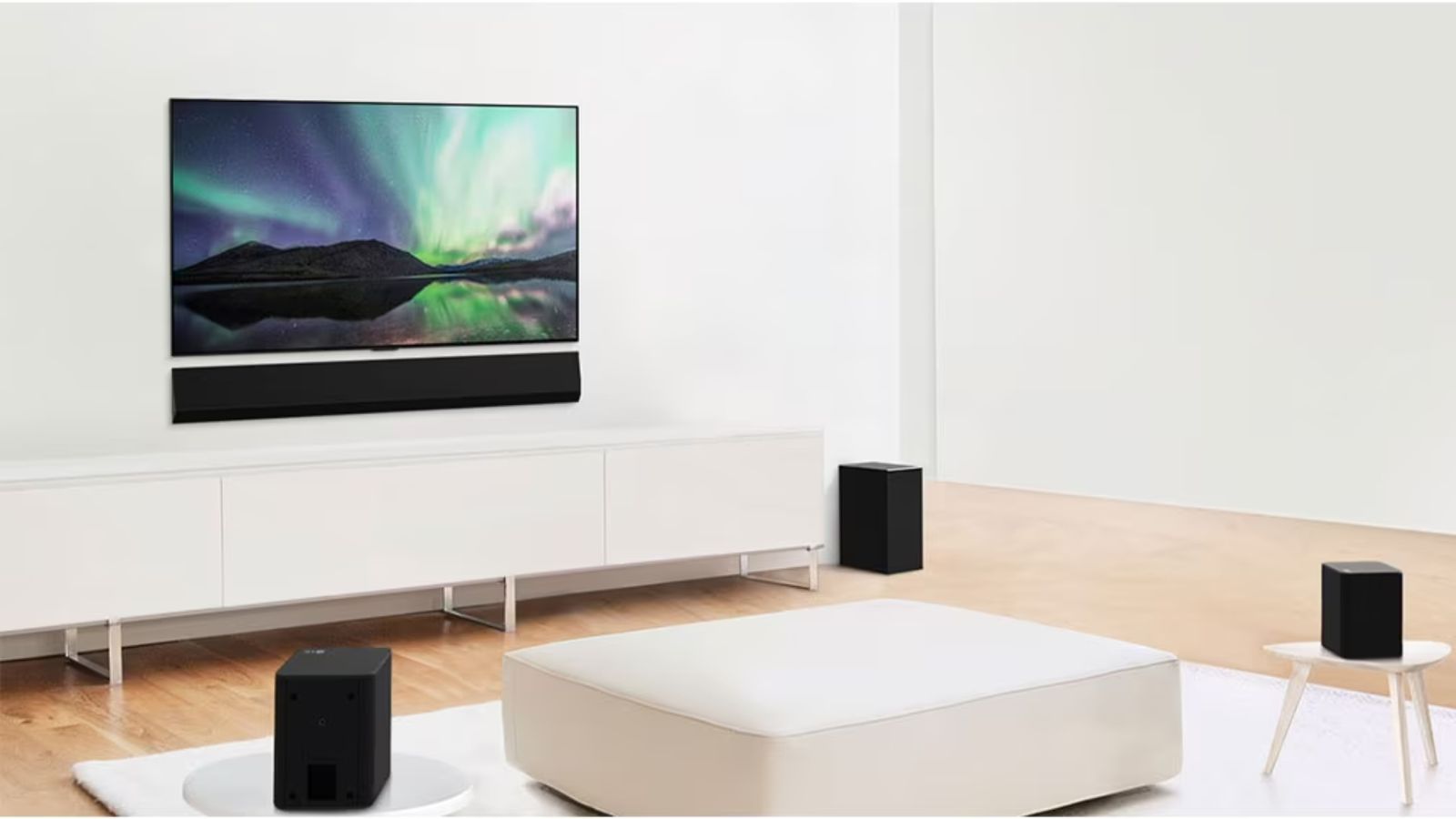 Image of a flatscreen TV featuring a North Lights screen in a living room filled with white furniture and black speakers.