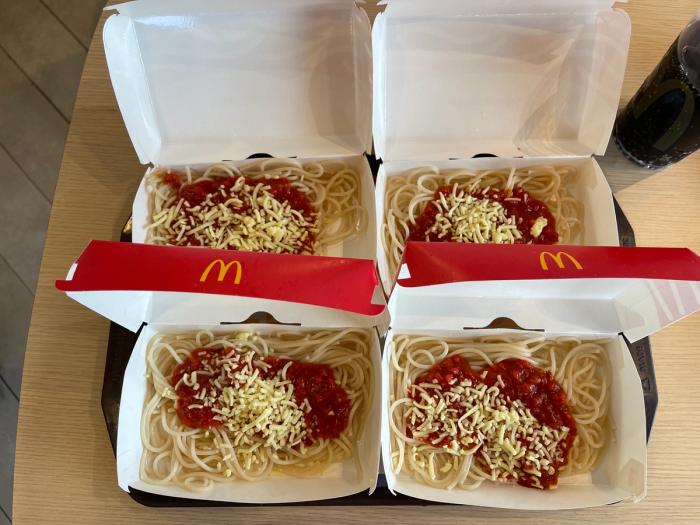 Four plates of McDonald's spaghetti.
