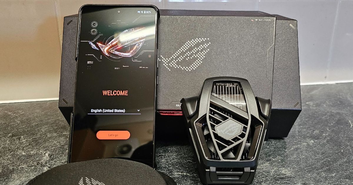 ASUS ROG Phone 8 Pro with Cooler next to it and the box behind it