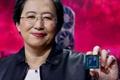 AMD CEO Lisa Su smiling as she underships Radeon GPUs