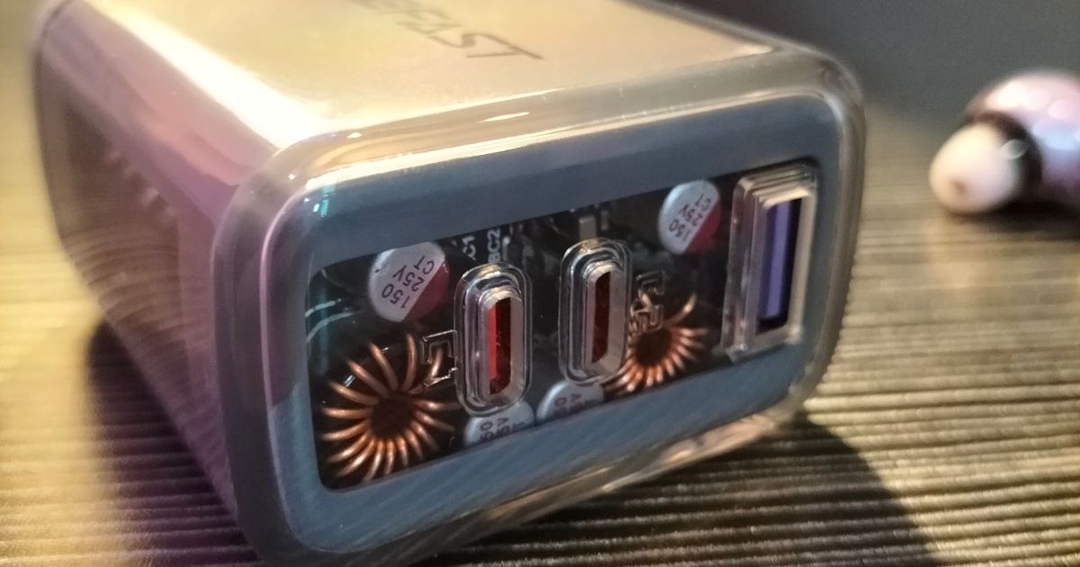 A grey multiport USB charger with a clear casing.