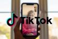 How to search on TikTok while on FaceTime - An image of a person facetiming with a TikTok logo on the foreground
