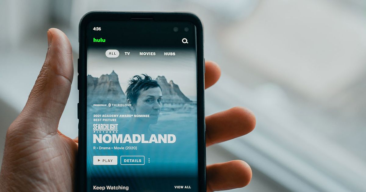 Someone with the Hulu app loaded up on their smartphone, with Nomadland featured on the home screen.