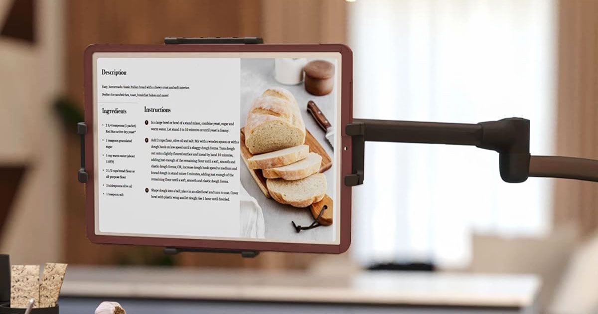 An extended black stablet holder with a tablet mounted to it, a recipe for bread on the screen.