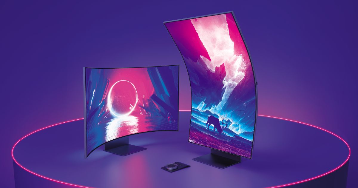 Two monitors, one horizontal and one vertical, on top of a purple plinth with pink lighting around the edge.