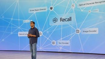 Pavan Davuluri, Microsoft Head of Windows and Surfaces, on-stage in front of a Recall presentation