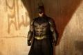 Batman standing in front of a wall with a shadow from him in Arkham Shadow key art
