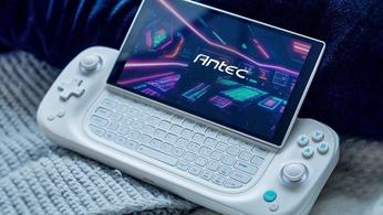 A white Antec Core HS gaming handheld on a blanket with the screen slid up to reveal a keyboard