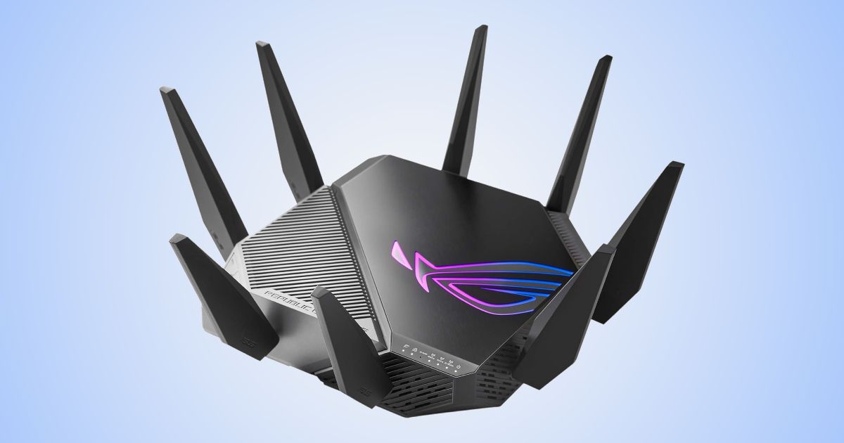 A black WiFi router with eight antennae pointing upwards and pink and blue lighting on top in front of a white and blue gradient backdrop.