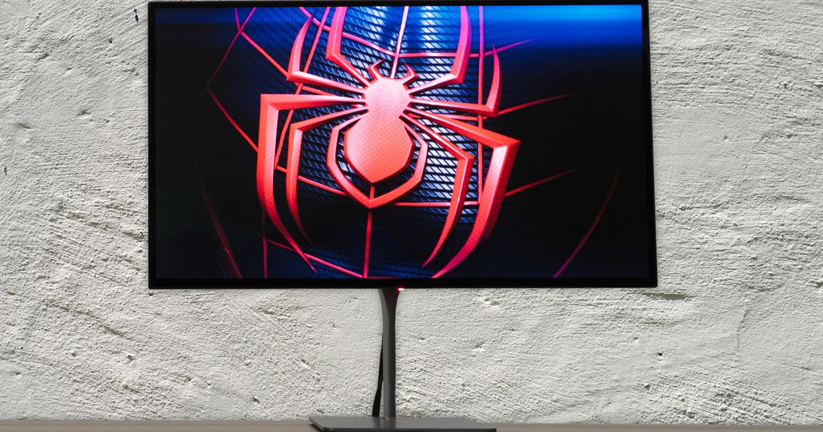 A Dough Spectrum Black gaming monitor with Miles Morales' Spider-Man logo on the screen
