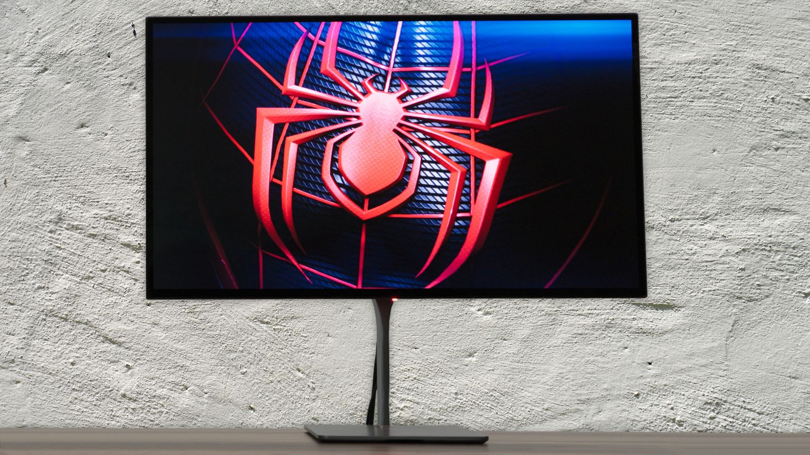 A Dough Spectrum Black OLED monitor with Miles Morales' Spider-Man logo on the front