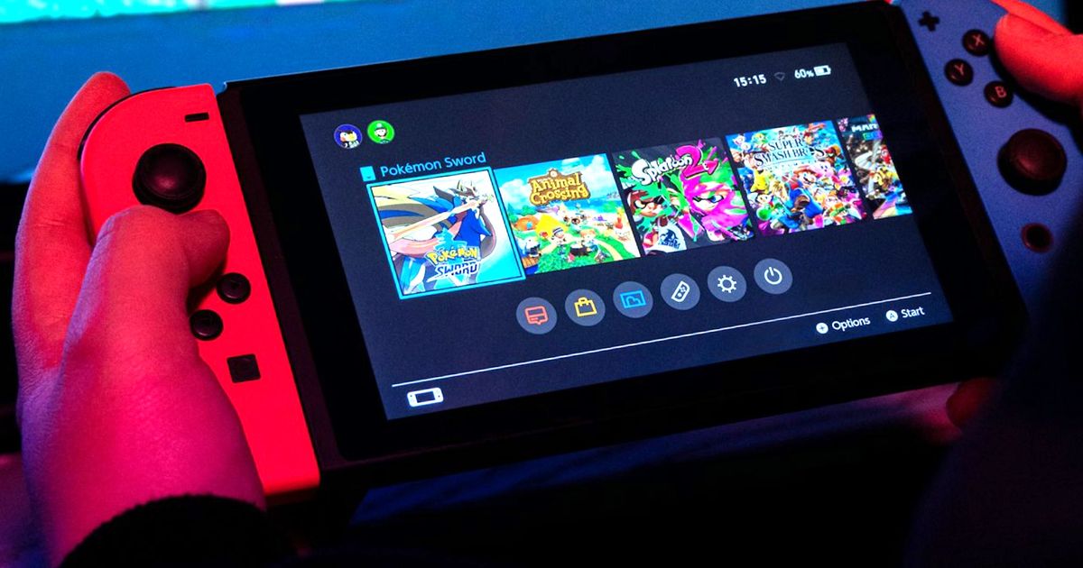 A shot of a Nintendo switch console in a user’s hand 
