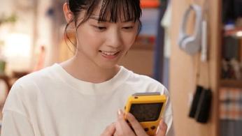 Live action Pokémon TV series - Madoka looking at the back of a Game Boy pocket