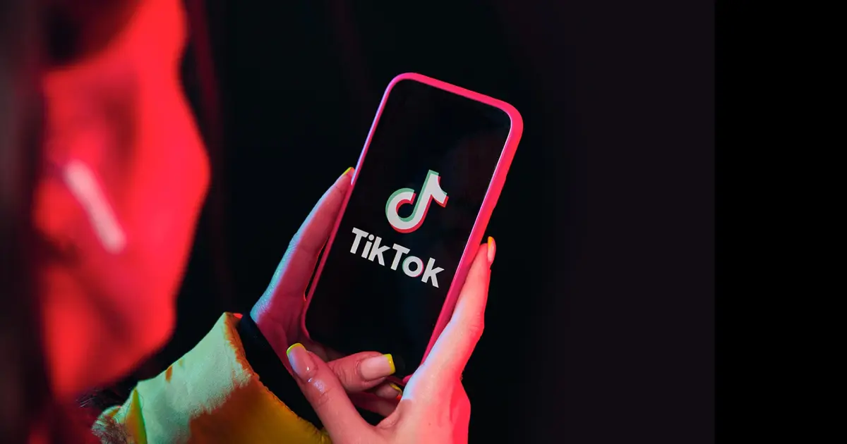 TikTok "Verify to continue" - An image of a person seeing TikTok on their phone