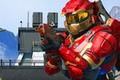 An image of a red and gold mark v Spartan firing an assault rifle in Halo Infinite with raytraced sun shadows enabled 