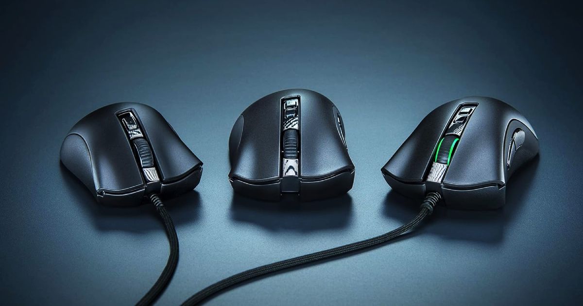 Three black PC mice in a row, two of which are plugged in, and the one at the end featuring a green light around the scroll wheel.