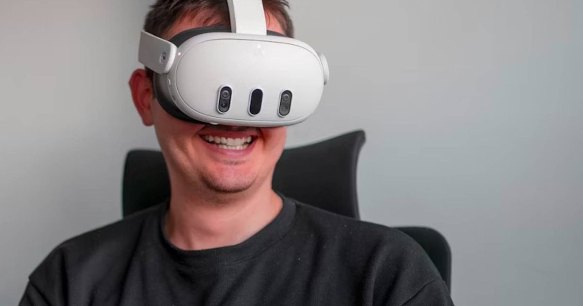 A user wearing a Meta Quest 3 VR headset while smiling
