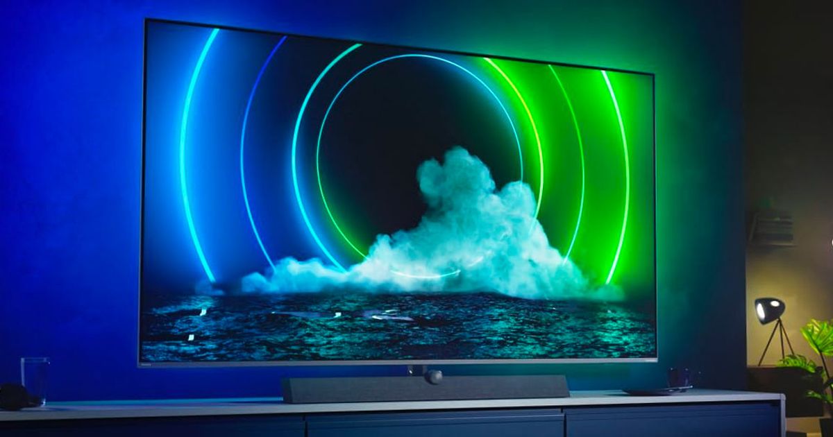 Image of a TV mounted on a wall with blue and green circles on the display.