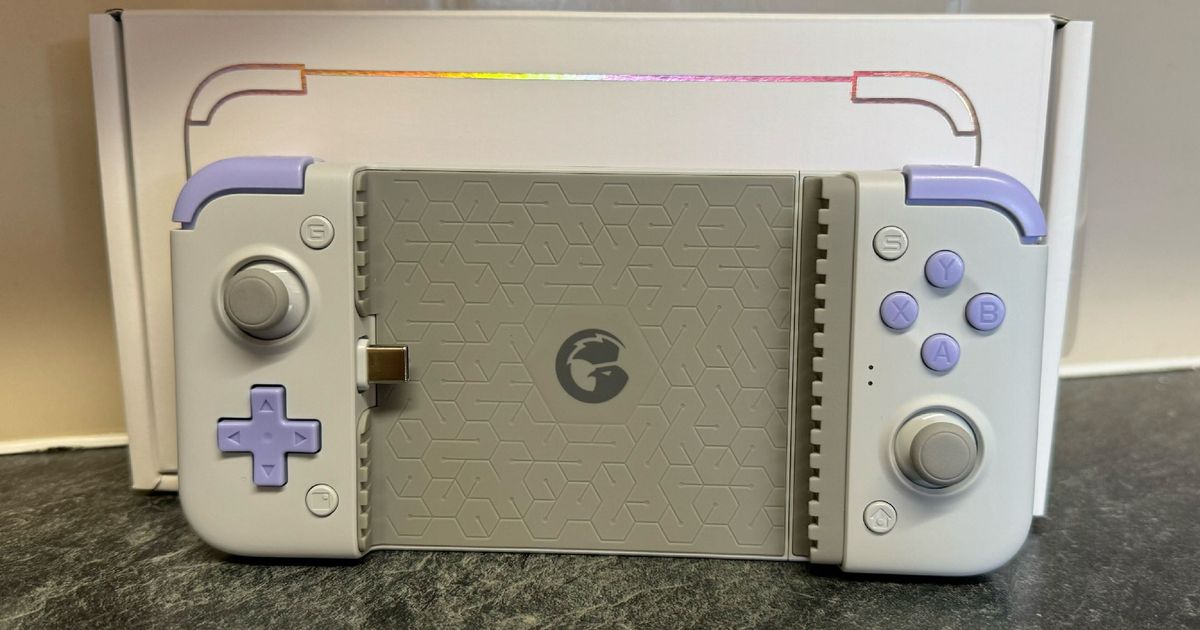 Gamesir X2s in front of the box and a tiled wall
