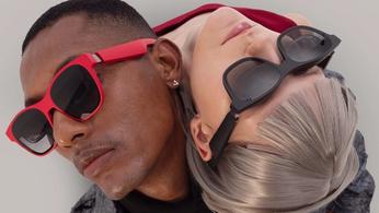An intertwined man and woman wearing a pair of XReal Air 2 augmented reality smart glasses