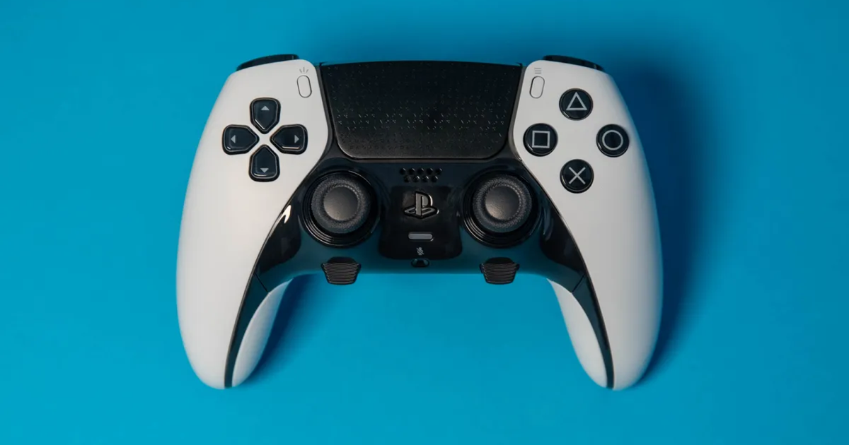 white and black playstation 5 controller on blue background