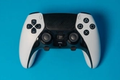white and black playstation 5 controller on blue background