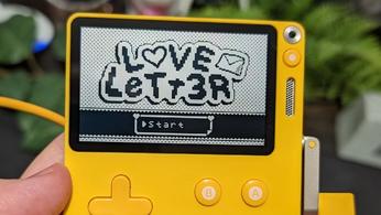 Love Letter indie game on a yellow Playdate for Aaron Nielsen's proposal