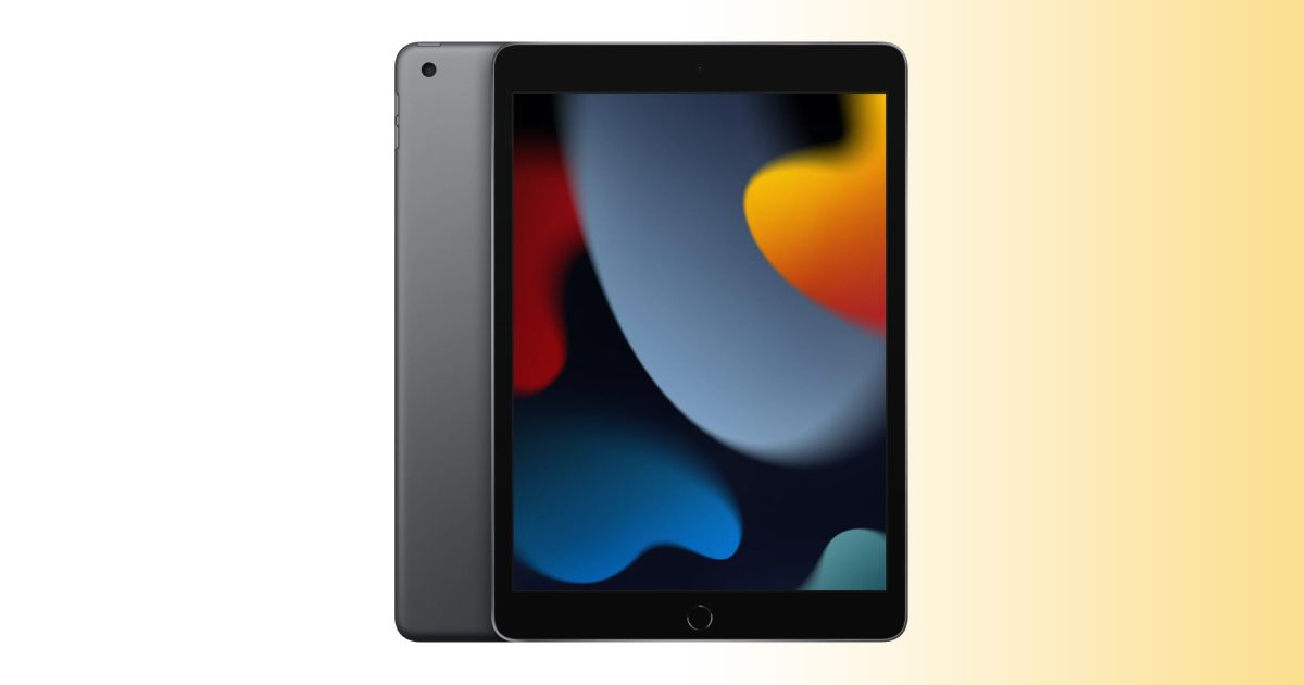 A grey and black iPad with spots of orange, blue, red, and green on the display, with the tablet in front of a white and orange gradient background.