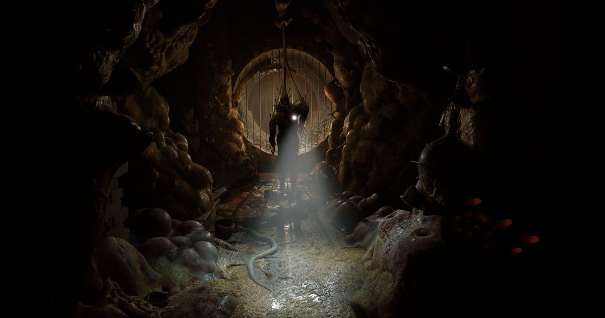 A figure shines a torch in a dark tunnel