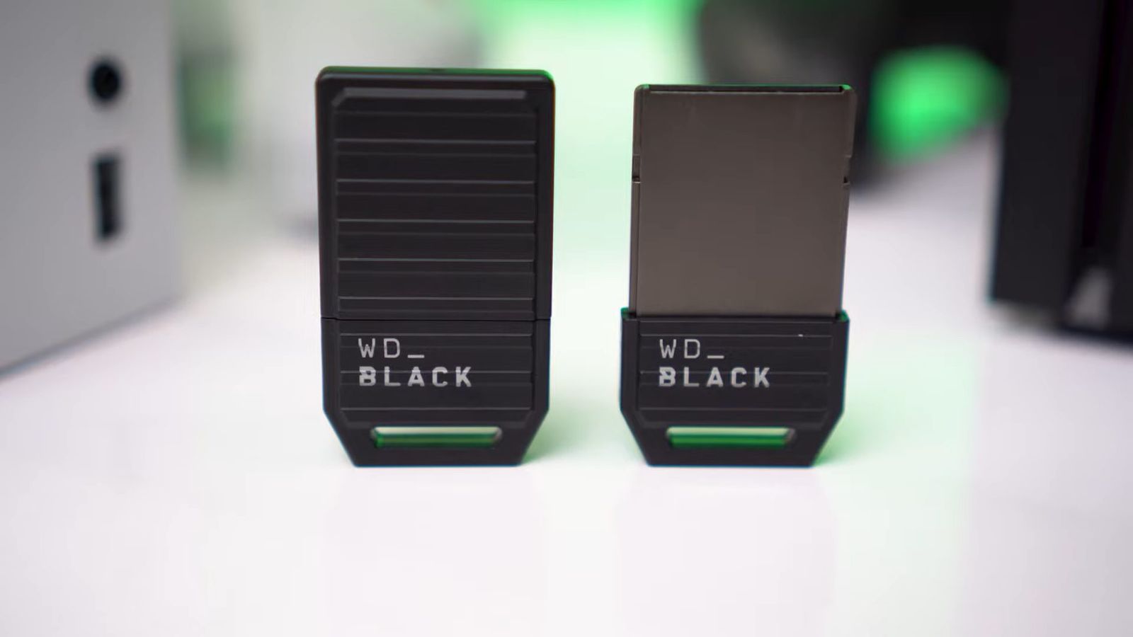 Two WD_Black C50 Xbox Expansion Cards next to each other, one in a heat sink cover, the other bare.