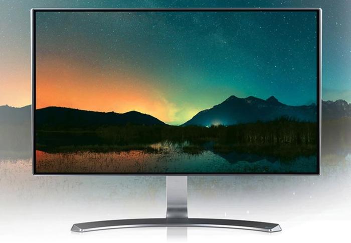 Image of a silver IPS LG monitor featuring a mountain scene on the display with an orange and green skyline.