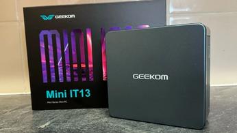 Geekom Mini IT13 in front of the box and a tiled wall