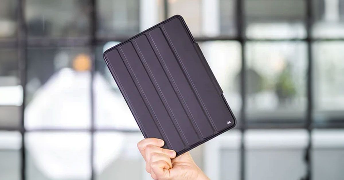 Someone holding up a tablet in a black rugged case.
