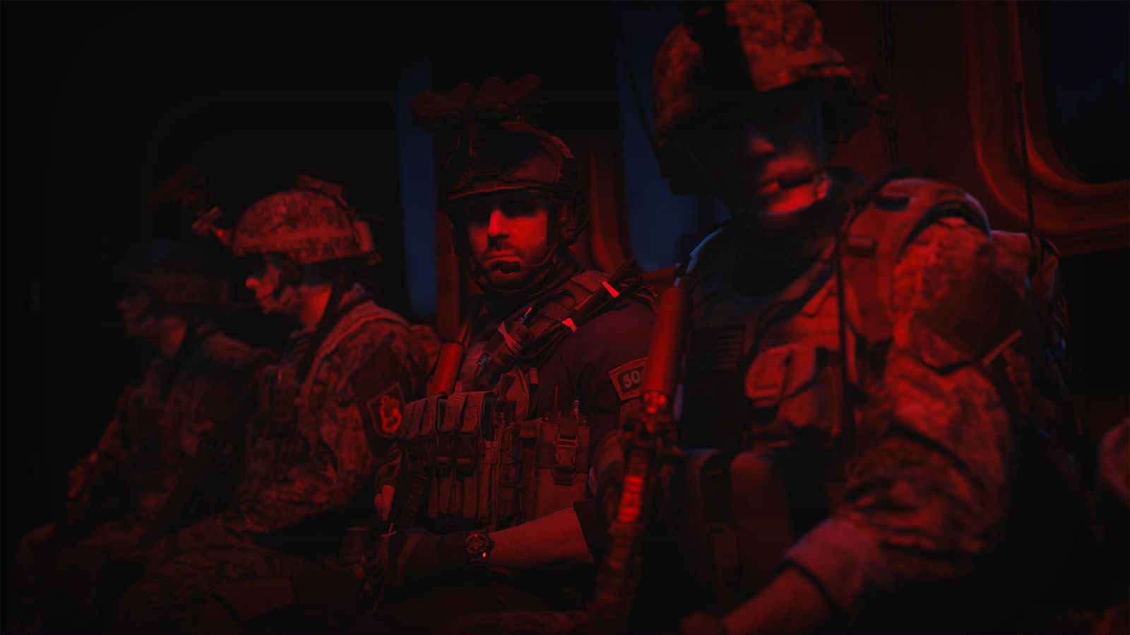 Soldiers bathed in red light, waiting to start a mission