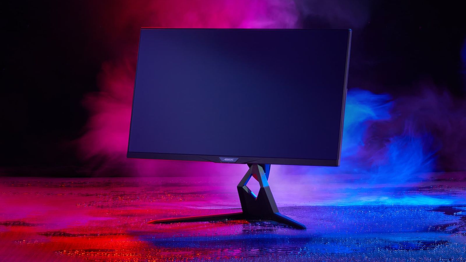 Image of a black gaming monitor surrounded by red and blue lighting and smoke.