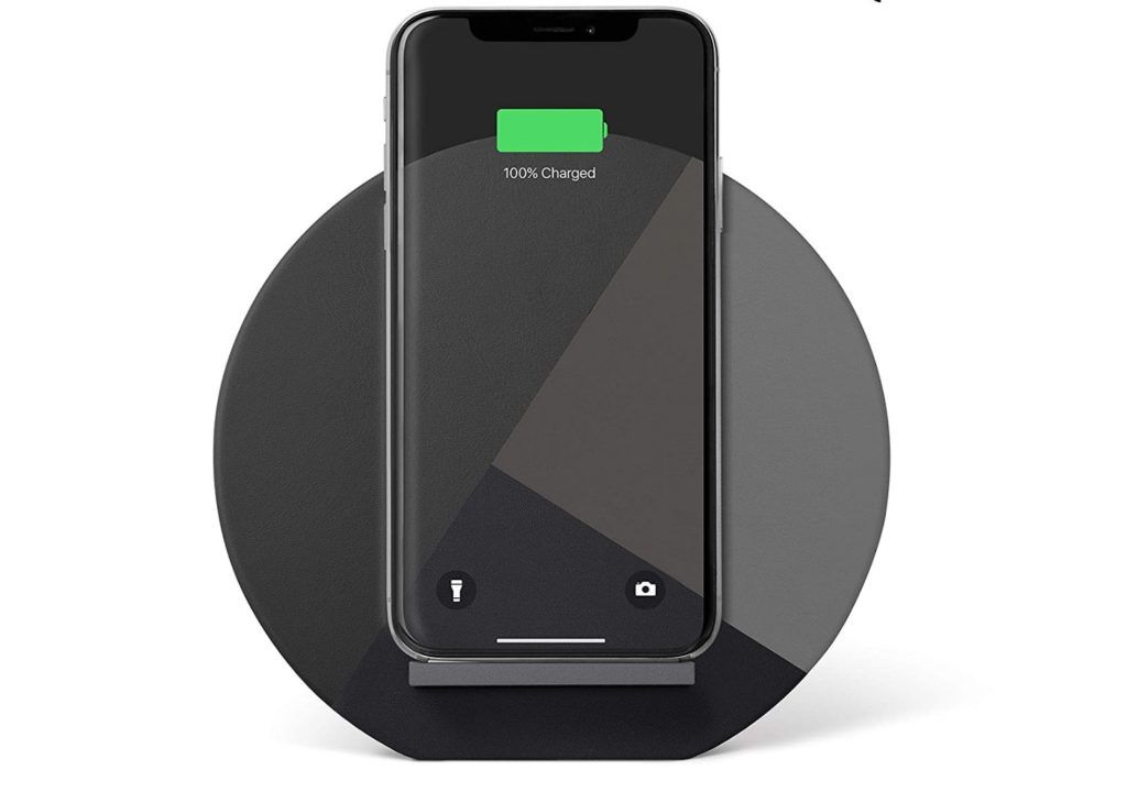 Native Union Dock product image of a black circular charging dock with a black smartphone attached.
