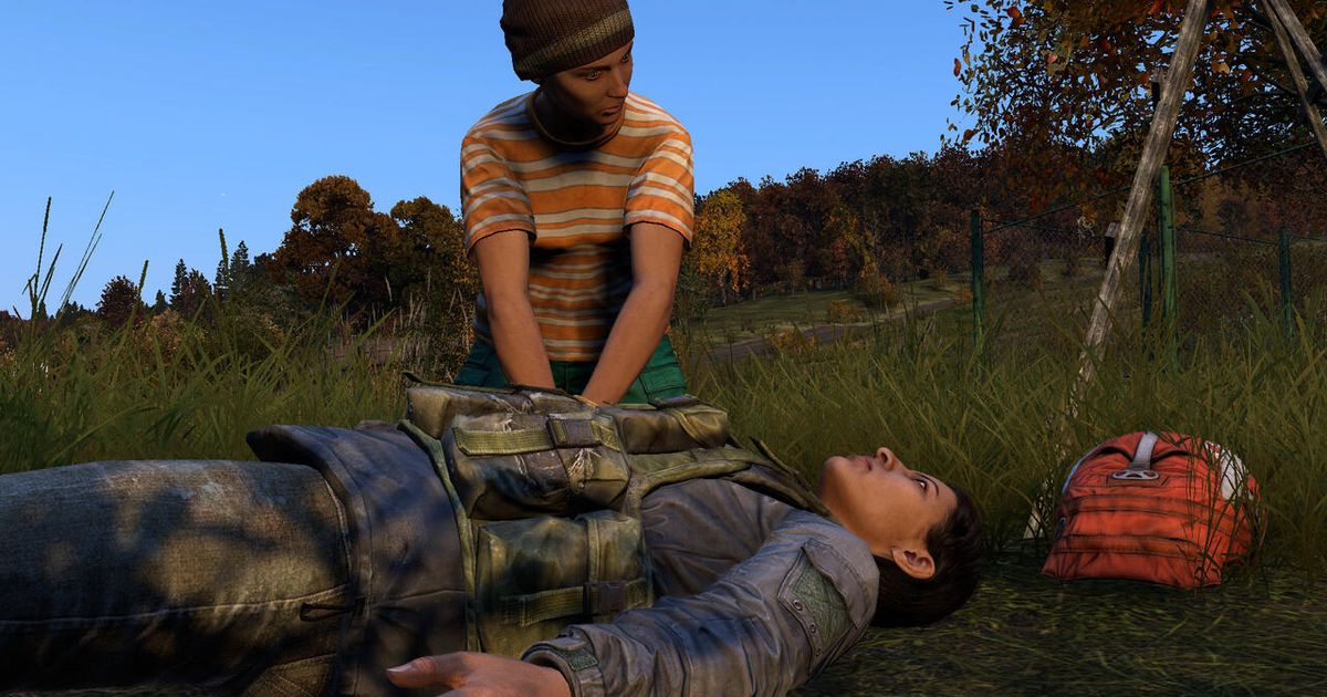 Image of DayZ reviving injured player with blue sky and trees in background