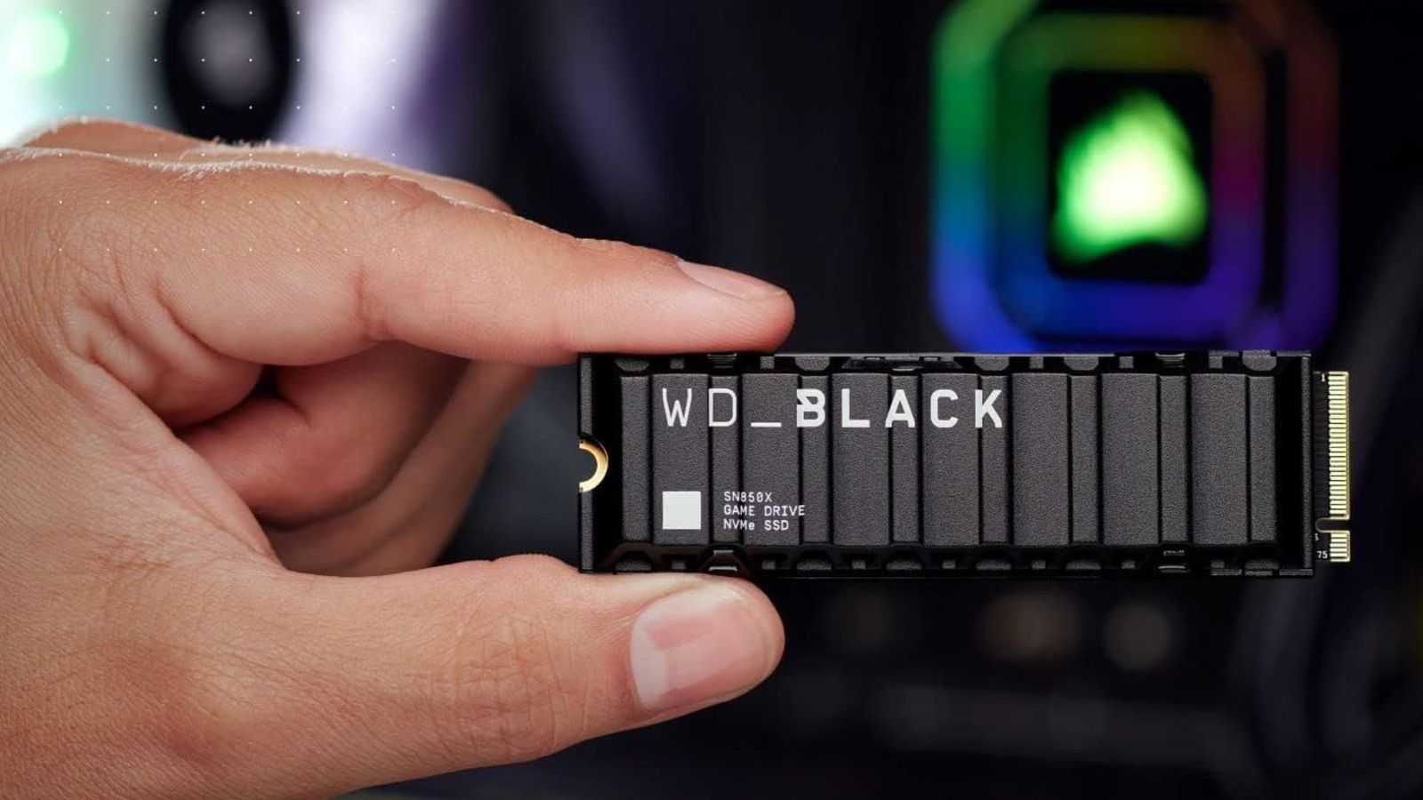 A WD_Black SN850X with a heatsink being held by a random hand