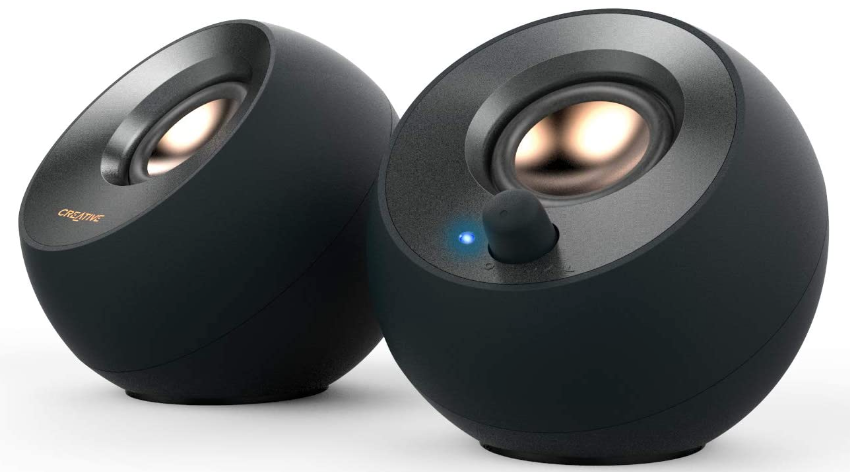 Creative Pebble v2 product image of two small, circular, black pebble speakers.