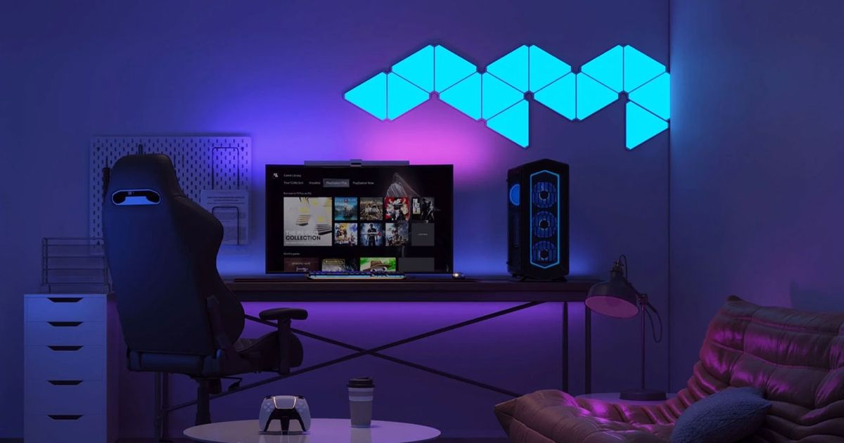 A set of blue panel lights mounted to a wall above a gaming setup.
